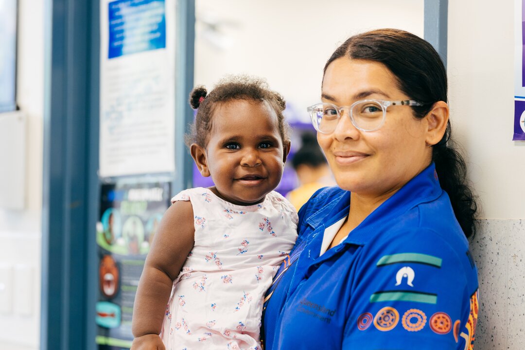 Health worker holding baby